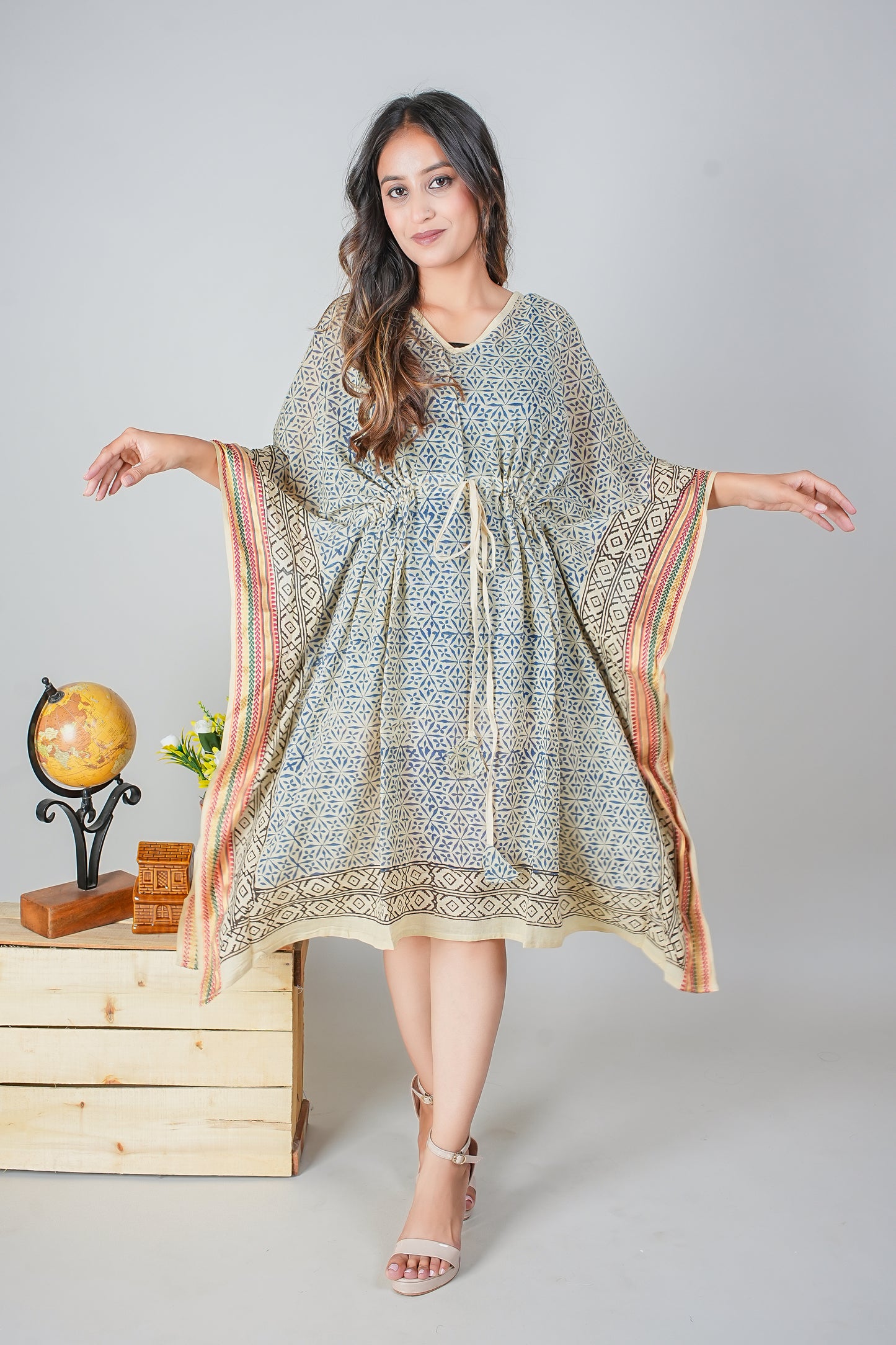 Woman wearing a patterned dress with a plain background